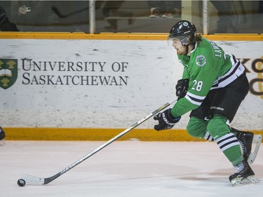 University of Saskatchewan Huskies forward John Lawrence moves the puck against the University of Calgary Dinos in CIS Men's Hockey playoff action at Rutherford rink on the U of S campus on Saturday, February 27th, 2016.
