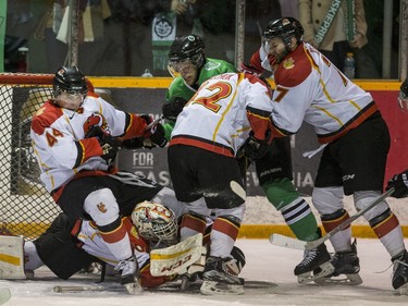 University of Saskatchewan Huskies and University of Calgary Dinos swarm the Dinos net in CIS Men's Hockey playoff action at Rutherford rink on the U of S campus on Saturday, February 27th, 2016.