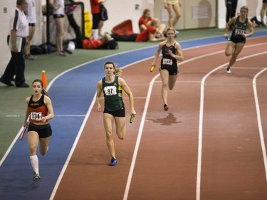 University of Calgary Dinos' Natalie McDougall (L) leads the race during the Canada West Track and Field championships at the Saskatoon Field House on the U of S campus, February 27, 2016.
