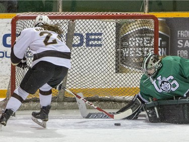 University of Saskatchewan Huskies goalie Cassidy Hendricks makes a save against University of Manitoba Bisons forward Alanna Sharman in CIS Women's Hockey action, February 20, 2016.