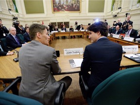 Prime Minister Justin Trudeau talks with Vancouver mayor Gregor Robertson as he meets with the big city mayors, including Saskatoon Mayor Don Atchison, in the railway committee room on Parliament Hill in Ottawa on Friday.
