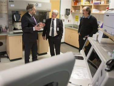 NDP Leader Tom Mulcair (L) is shown the lab area of the La Loche Community Health Centre while given a tour from Jean-Marc Desmeules CEO of the Keewatin Yatthe Regional Health Authority (C) and Thielrry Sereau Director of the the hospital on February 2, 2016.