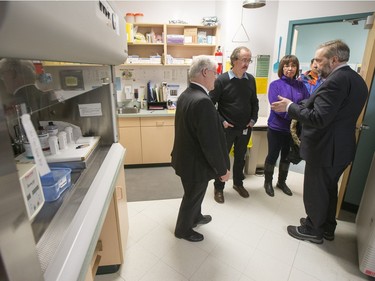 NDP Leader Tom Mulcair (R) and  Local MP Georgina Jolibois are shown the lab area of the La Loche Community Health Centre while given a tour from Jean-Marc Desmeules CEO of the Keewatin Yatthe Regional Health Authority (L) and Thielrry Sereau Director of the the hospital on February 2, 2016.