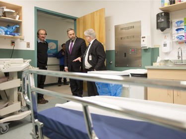 NDP Leader Tom Mulcair (C) is shown a hospital room of the La Loche Community Health Centre while given a tour from Jean-Marc Desmeules CEO of the Keewatin Yatthe Regional Health Authority (R) and Thielrry Sereau Director of the the hospital on February 2, 2016.