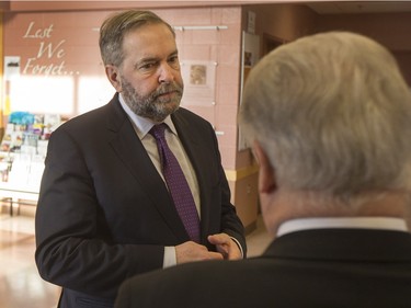 NDP Leader Tom Mulcair (L) is shown a main lobby of the La Loche Community Health Centre while given a tour from Jean-Marc Desmeules CEO of the Keewatin Yatthe Regional Health Authority on February 2, 2016.