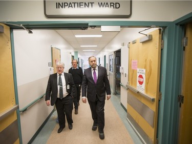 NDP Leader Tom Mulcair (R) is shown a the impatient ward of the La Loche Community Health Centre while given a tour from Jean-Marc Desmeules CEO of the Keewatin Yatthe Regional Health Authority (L) and Thielrry Sereau Director of the the hospital on February 2, 2016.