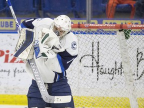 File Photo. Saskatoon Blades goalie Evan Smith has a rebound puck hit his mask after making a save against the Moose Jaw Warriors in WHL action on Sunday, February 28th, 2016.