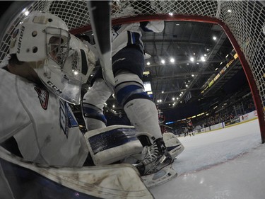 Saskatoon Blades goalie Evan Smith falls to the back of the net as the Moose Jaw Warriors score in WHL action on Sunday, February 28th, 2016.