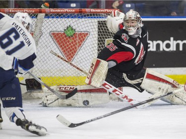 Moose Jaw Warriors goalie Brody Willms makes a save against Saskatoon Blades Josh Paterson in WHL action on Sunday, February 28th, 2016.