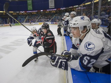 Saskatoon Blades Nikita Shoshnin, left, and Moose Jaw Warriors Dryden Hunt battle in front of the Blades bench in WHL action on Sunday, February 28th, 2016.