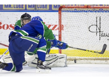 Swift Current Broncos goalie Taz Burman watches a bouncing puck just go wide against the Saskatoon Blades in WHL action  on Saturday, February 6th, 2016.