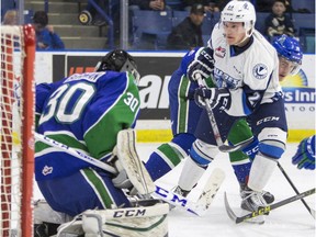 Saskatoon Blades forward Braylon Shmyr watches a puck go over Swift Current Broncos goalie Taz Burman in WHL action, Feb. 6, 2016.