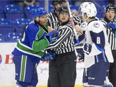 Officals attempt to control an agreement between Swift Current Broncos forward Arthur Miller and Saskatoon Blades forward Cameron Hausinger in WHL action on Saturday, February 6th, 2016.