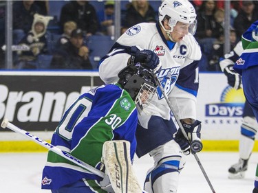 Saskatoon Blades forward Nick Zajac watches a deflected puck in front of Swift Current Broncos goalie Taz Burman in WHL action  on Saturday, February 6th, 2016.