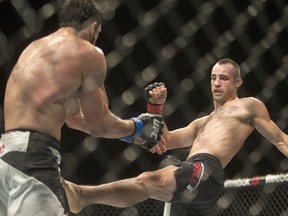 Shane Campbell (right) attempts a leg kick on Eliax Silverio in a lightweight bout at UFC Fight Night at Saskatoon's SaskTel Centre on Aug. 23, 2015