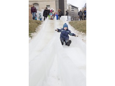 Three-year-old Jude Matic slides down an ice slide at Frosted Gardens on the Bessborough Hotel grounds, February 6, 2016.