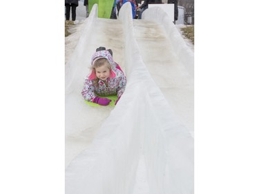 Four-year-old Keylie Lapointe slides down an ice slide at Frosted Gardens on the Bessborough Hotel grounds, February 6, 2016.