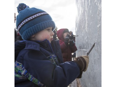 Three-year-old Jude Matic chisels some ice at Frosted Gardens on the Bessborough Hotel grounds, February 6, 2016.