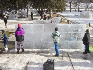 People chisel some ice at Frosted Gardens on the Bessborough Hotel grounds, February 6, 2016.