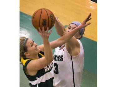 University of Saskatchewan Huskies #13 Delyce Emmerson with the upper hand on an unidentified Alberta Golden Panda at the net in CIS action at the PAC Centre, February 12, 2016.