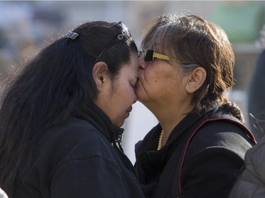 A friend, right, kisses the forehead of Connie Beauchene after she finishes speaking at city hall prior to going on a walk for missing and murdered indigenous women on Sunday, February 14th, 2016.