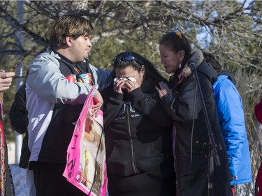 Lori Nicotine, centre, hugs Connie Beauchene after she finishes speaking at city hall prior to going on a walk for missing and murdered indigenous women on Sunday, February 14th, 2016.