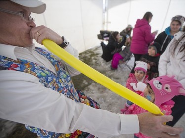 Warren Johnson of Balloon Funn, left, makes a balloon animal for Angel Gardiner, age 2, and Nevaeh Knarr, age 5, during the Family Day Skating Party at Meewasin Skating Rink on Monday, February 15th, 2016.