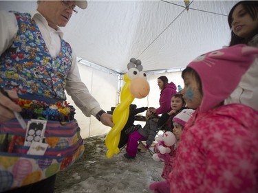 Warren Johnson of Balloon Funn, left, makes a balloon giraffe for Angel Gardiner, age 2, and Nevaeh Knarr, age 5, during the Family Day Skating Party at Meewasin Skating Rink on Monday, February 15th, 2016.