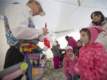 Warren Johnson of Balloon Funn, left, makes a balloon animal for Angel Gardiner, age 2, and Nevaeh Knarr, age 5, during the Family Day Skating Party at Meewasin Skating Rink on Monday, February 15th, 2016.