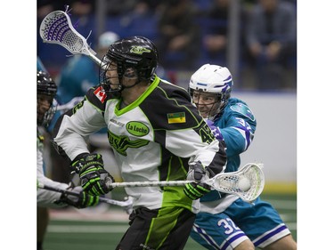 Saskatoon Rush forward Mark Matthews keeps the ball away from Rochester Knighthawks defender Jon Sullivan in NLL first half action on Friday, February 19th, 2016.