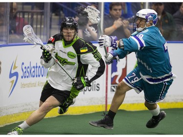 Saskatoon Rush forward Ben McIntosh moves the ball past Rochester Knighthawks defender Sid Smith in NLL first half action on Friday, February 19th, 2016.