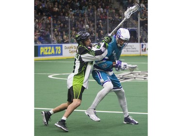 Saskatoon Rush transition Jeremy Thompson checks Rochester Knighthawks forward Dan Dawson in NLL first half action on Friday, February 19th, 2016.