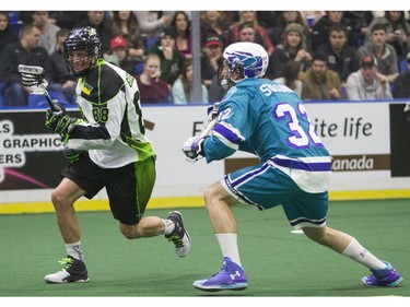 SASKATOON, SASK--FEBRUARY 19 2016 0220 Sports Rush- Saskatoon Rush forward Zack Greer moves the ball past Rochester Knighthawks defender Jon Sullivan in first half action on Friday, February 19th, 2016.