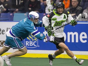 Saskatoon Rush forward Zack Greer moves the ball past Rochester Knighthawks defender Graeme Hossack in NLL first half action on Friday, February 19th, 2016.