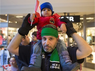 Abdul Raheen Al-Barmawi poses for a photograph before he and other newly arrived Syrian refugees handed out roses at Lawson Heights Mall in Saskatoon to thank Canadians, February 21, 2016.