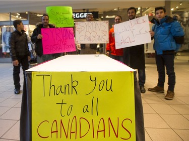 Newly arrived Syrian refugees handed out roses at Lawson Heights Mall in Saskatoon to thank Canadians, February 21, 2016.