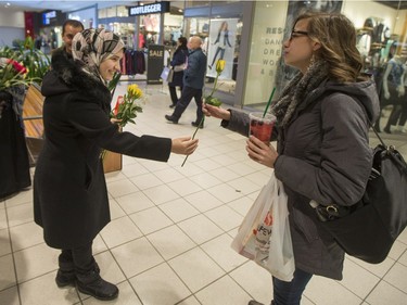 Newly arrived Syrian refugees hand out roses at Lawson Heights Mall in Saskatoon to thank Canadians, February 21, 2016.