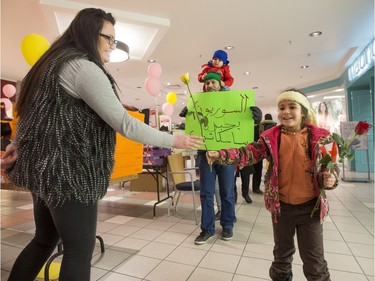 Newly arrived Syrian refugees hand out roses at Lawson Heights Mall in Saskatoon to thank Canadians, February 21, 2016.