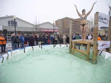 A Polar Dipper jumps in to a small pool prior to the Polar Dip to fight human trafficking at the Farmers market on Saturday, February 27th, 2016.