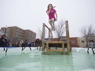 A Polar Dipper jumps into a small pool prior to the Polar Dip to fight human trafficking at the Saskatoon Farmers' Market, February 27, 2016.