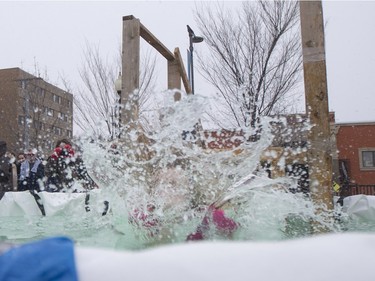 A Polar Dipper jumps into a small pool prior to the Polar Dip to fight human trafficking at the Saskatoon Farmers' Market, February 27, 2016.