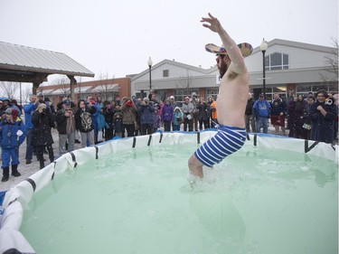 A Polar Dipper jumps into a small pool prior to the Polar Dip to fight human trafficking at the Saskatoon Farmers' Market, February 27, 2016.
