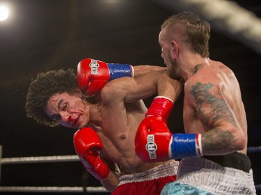 Justin Hacko, right, lands a punch on Wayne Smith during the At Last: Championship boxing at Prairieland Park on Saturday, February 27th, 2016.