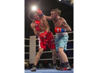 Justin Hacko, right, lands a punch on Wayne Smith during the At Last: Championship boxing at Prairieland Park on Saturday, February 27th, 2016.