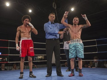 Justin Hacko (R) is declared the winner after taking on Wayne Smith during the At Last: Championship boxing at Prairieland Park, February 27, 2016.