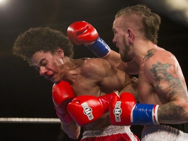 Justin Hacko, right, lands a punch on Wayne Smith during the At Last: Championship boxing at Prairieland Park on Saturday, February 27th, 2016.