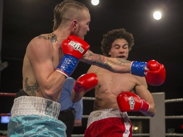 Justin Hacko (R) lands a punch on Wayne Smith during the At Last: Championship boxing at Prairieland Park, February 27, 2016.