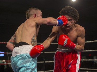 Justin Hacko, right, lands a punch on Wayne Smith during the At Last: Championship boxing at Prairieland Park on Saturday, February 27th, 2016.