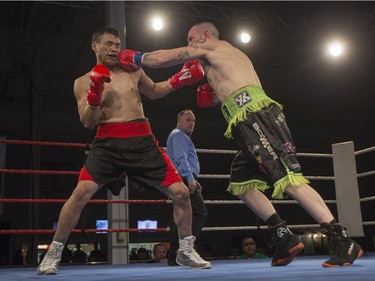 Ken Huber, right, lands a punch on Clay Dumais during the At Last: Championship boxing at Prairieland Park on Saturday, February 27th, 2016.