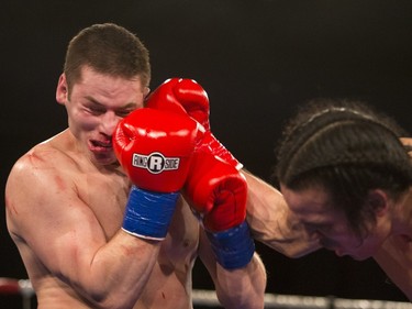 Matt Dumais, right, lands a punch on Kelly Paige during the At Last: Championship boxing at Prairieland Park on Saturday, February 27th, 2016.